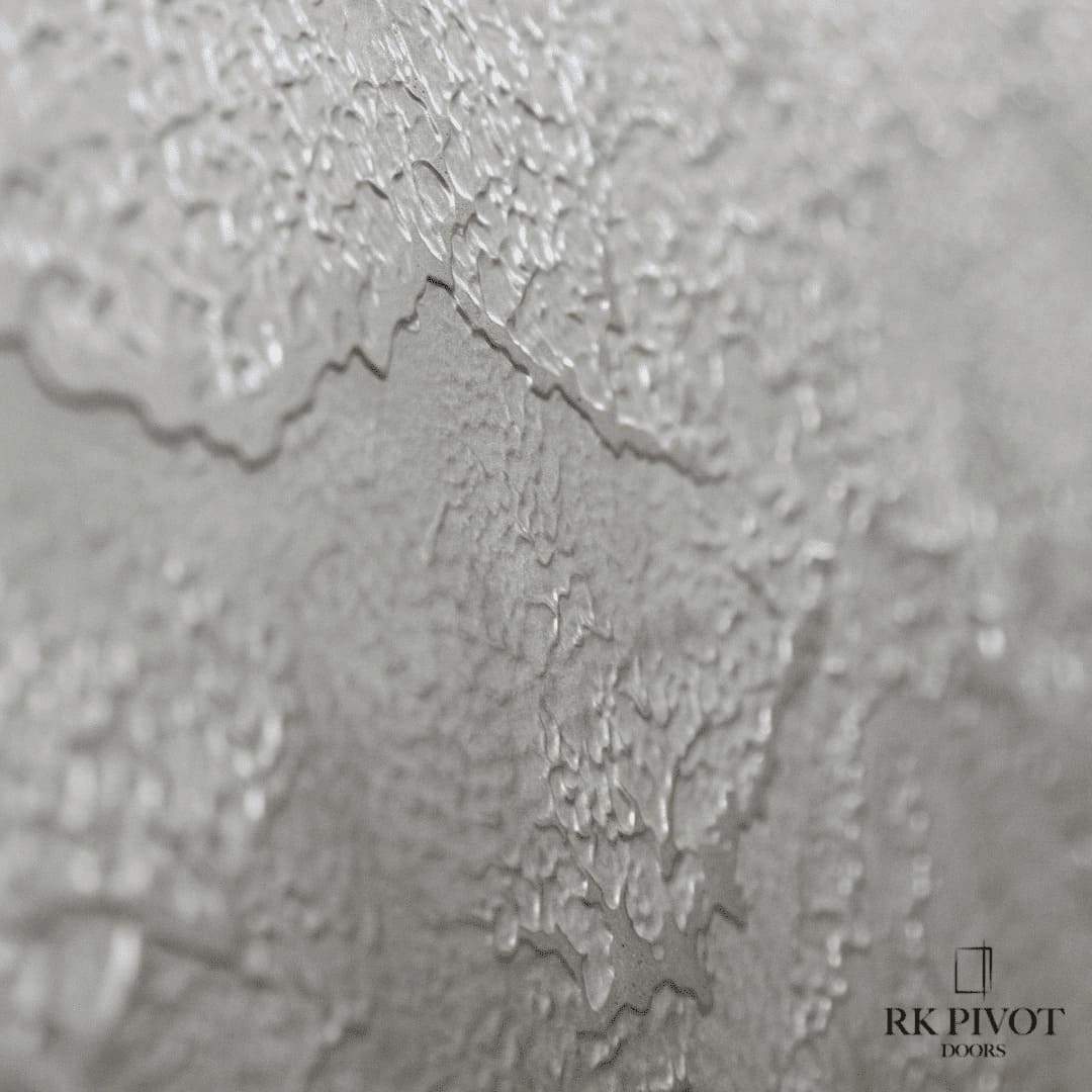 Oversized ROKA pivot entry door with liquid metal cladding installed on a luxury Toronto home